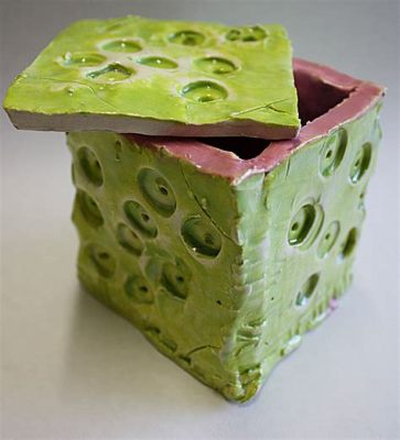 slab art definition: The innovative technique of slab art involves shaping and forming wet clay into various three-dimensional forms on a flat surface.